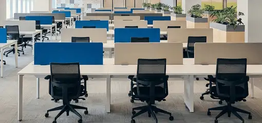 Modern open-plan office space featuring clean workstations, ergonomic chairs, and sanitized carpets provided by professional office cleaning services in Bakersfield, CA.