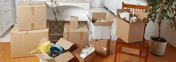 Packed moving boxes and household items in a kitchen before move-out or move-in cleaning, Bakersfield, CA.